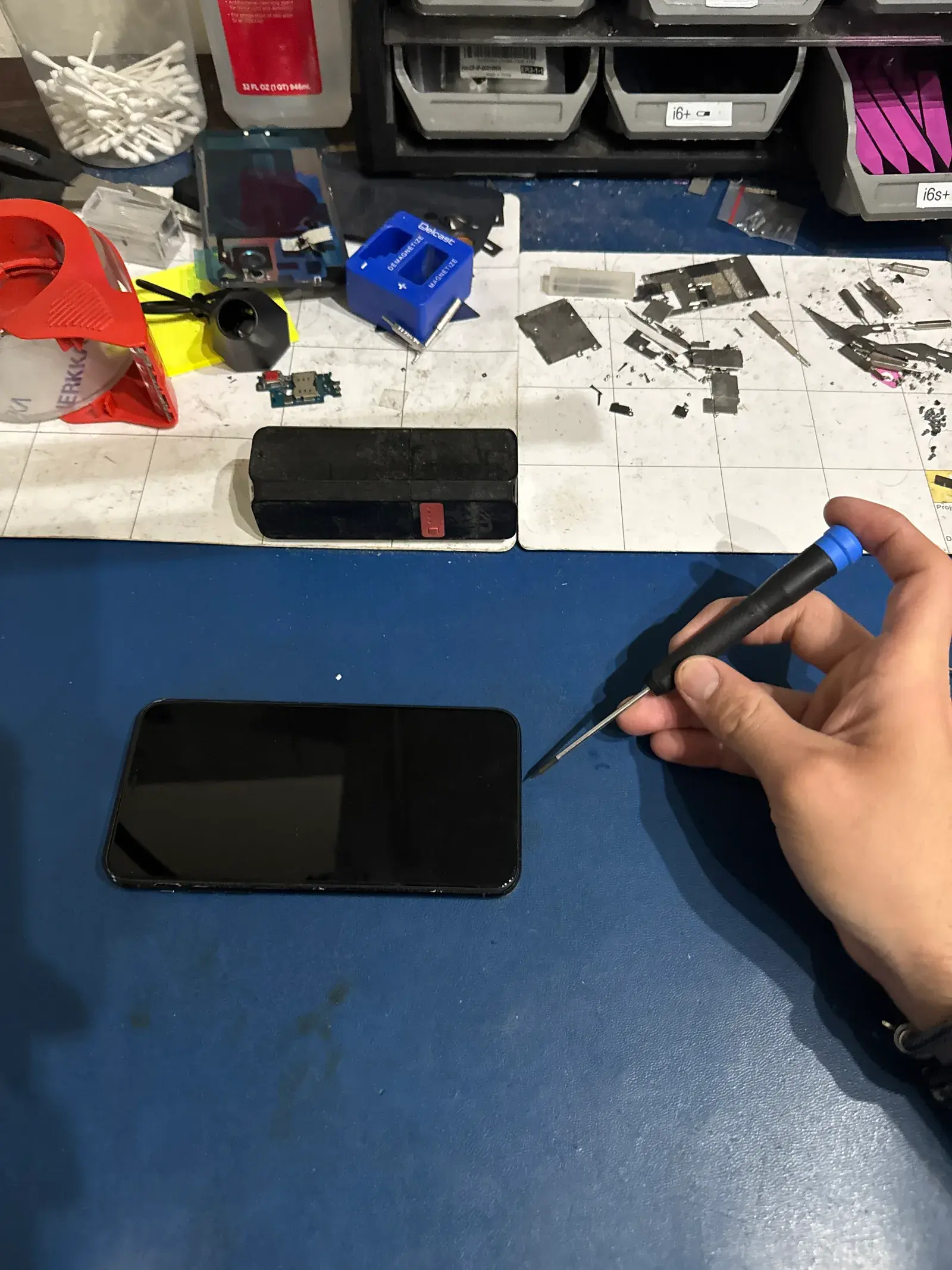 A phone opened up on the repair bench